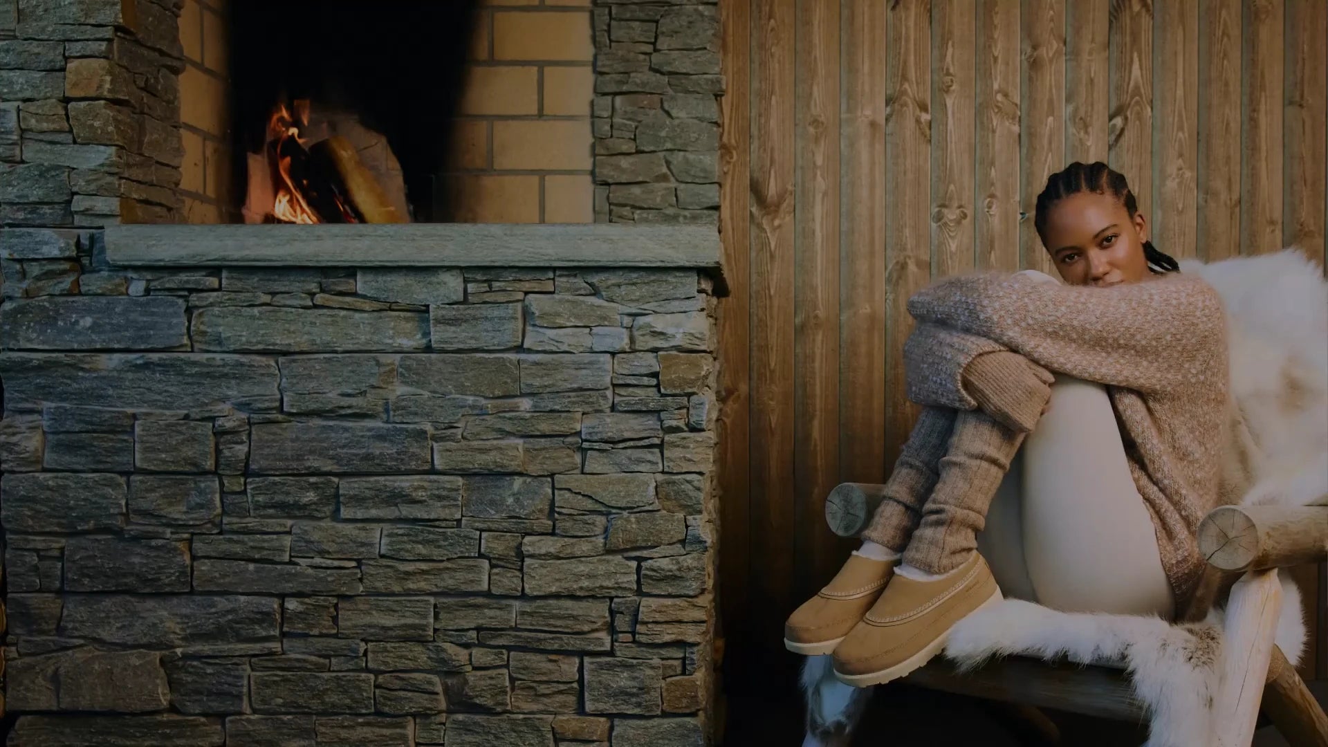 Cozy SOREL slippers by fireplace
